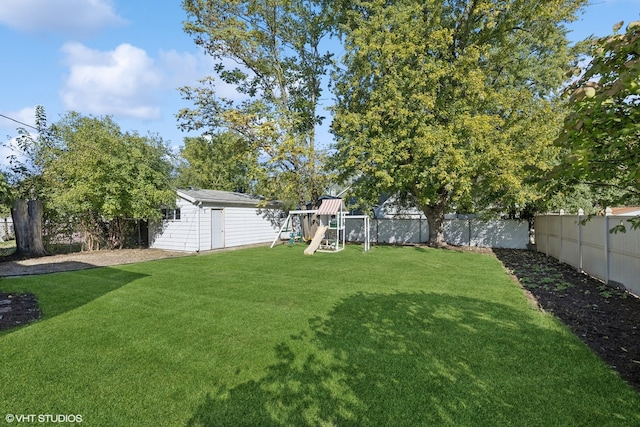 view of yard featuring an outdoor structure and a playground