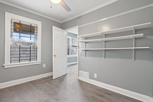 interior space with crown molding, ceiling fan, and hardwood / wood-style flooring