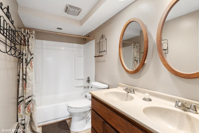 full bath with visible vents, toilet, shower / bath combo with shower curtain, and a sink