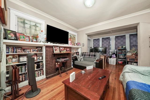 living room with wood-type flooring and ornamental molding