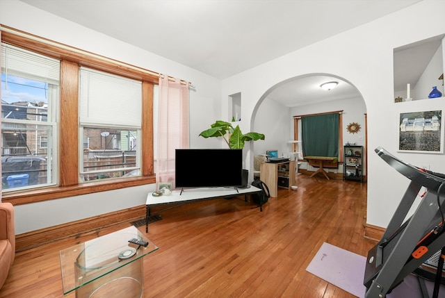 workout room with hardwood / wood-style flooring and lofted ceiling