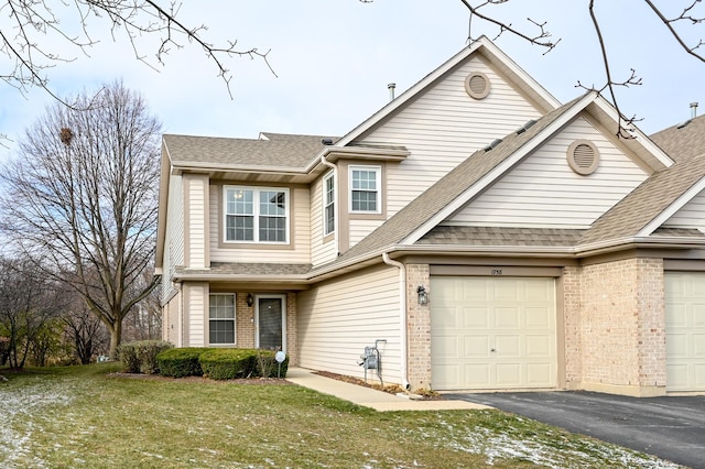 view of front facade featuring a front yard and a garage