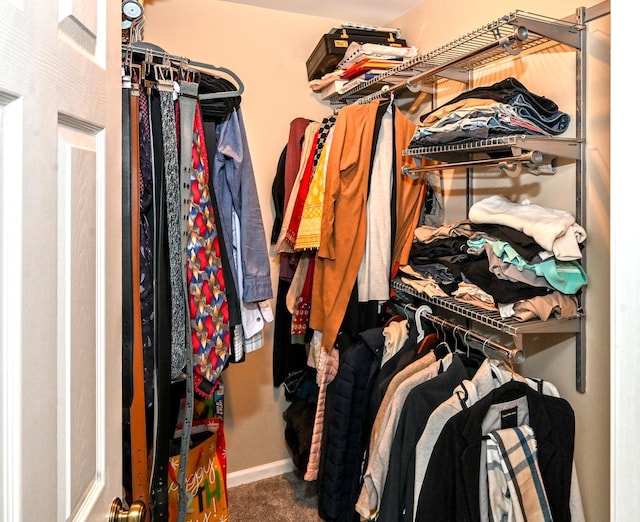 walk in closet with carpet flooring