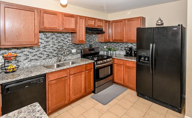 kitchen with sink, backsplash, light stone counters, and black appliances