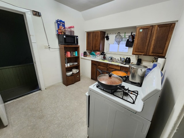 kitchen with white range and sink