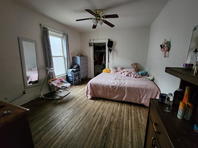 bedroom with hardwood / wood-style floors and ceiling fan