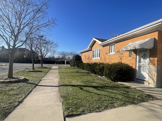 view of side of property with a lawn