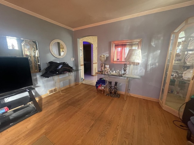 interior space with crown molding and light wood-type flooring