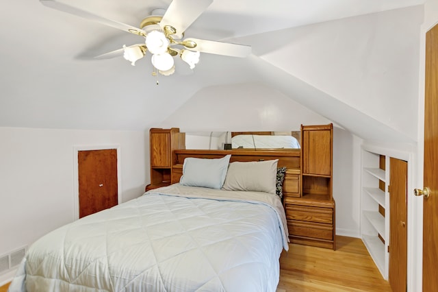 bedroom featuring ceiling fan, vaulted ceiling, and light hardwood / wood-style flooring