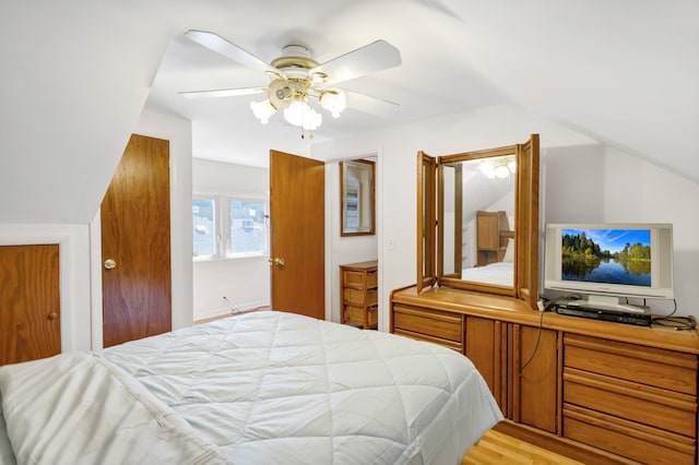 bedroom with ceiling fan, lofted ceiling, and light hardwood / wood-style flooring