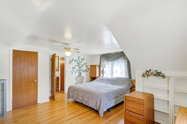 bedroom with ceiling fan, light hardwood / wood-style flooring, and vaulted ceiling