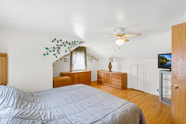 bedroom featuring hardwood / wood-style floors, ceiling fan, and lofted ceiling