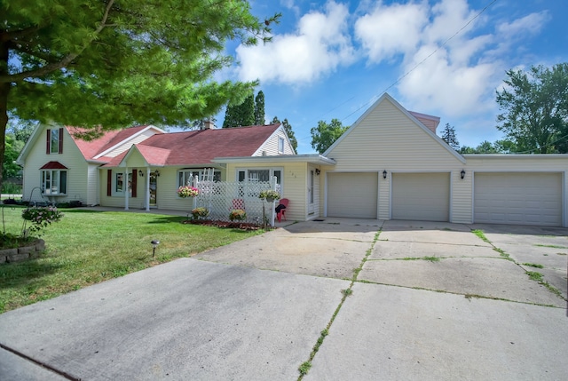 view of front of home featuring a front lawn, a porch, and a garage