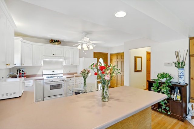 kitchen featuring kitchen peninsula, light wood-type flooring, white appliances, ceiling fan, and white cabinetry