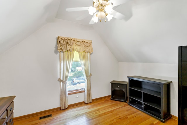 additional living space featuring ceiling fan, light hardwood / wood-style floors, and vaulted ceiling