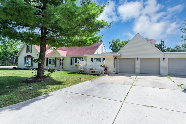 view of front of home with a front lawn and a garage