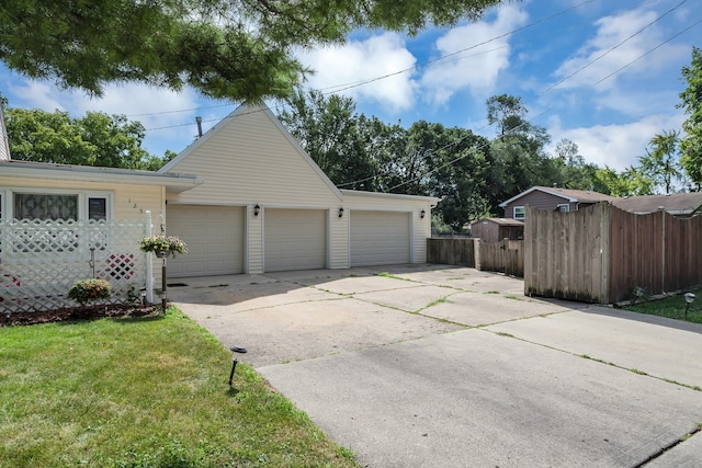 garage featuring a lawn