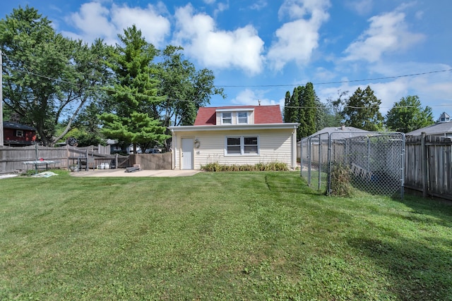 rear view of property with a patio and a lawn