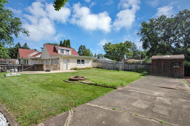 view of yard with a fire pit and a storage shed