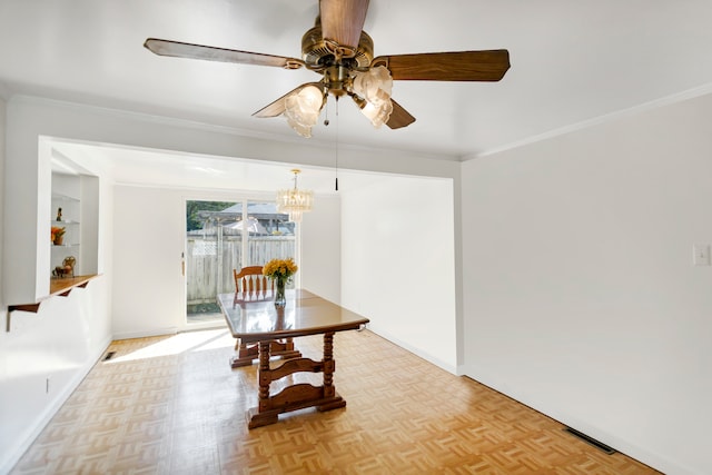 dining space with ceiling fan with notable chandelier, light parquet floors, and crown molding