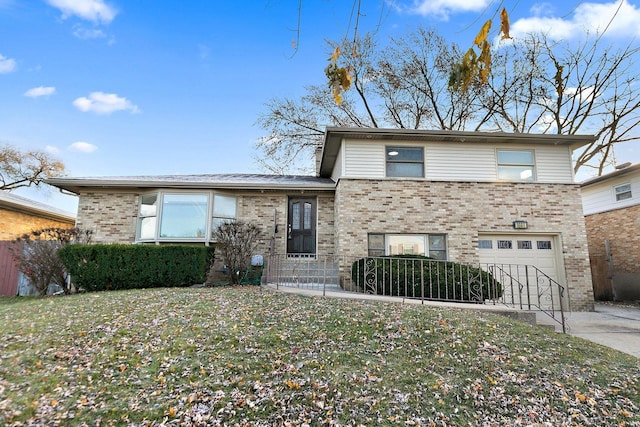 view of front of property featuring a front yard and a garage