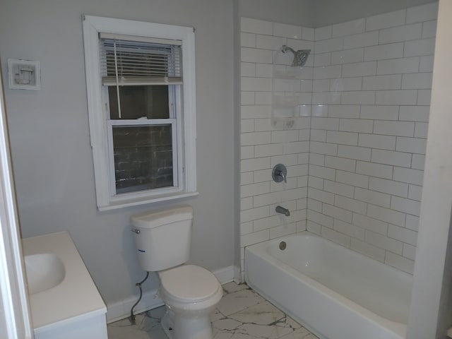 full bathroom featuring toilet, vanity, and tiled shower / bath