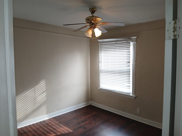 unfurnished room featuring ceiling fan and dark wood-type flooring