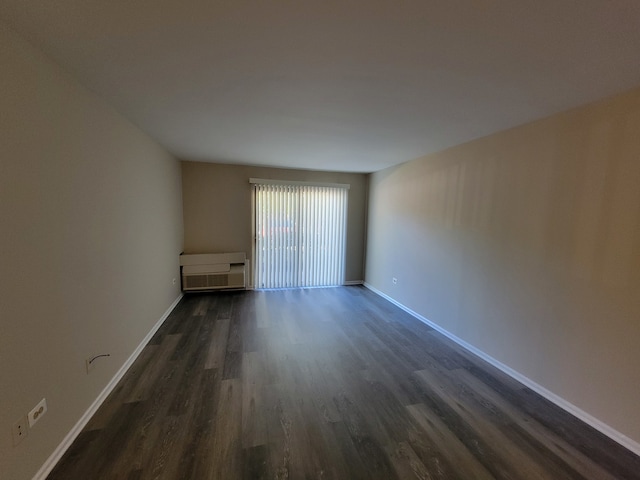 empty room with dark hardwood / wood-style floors