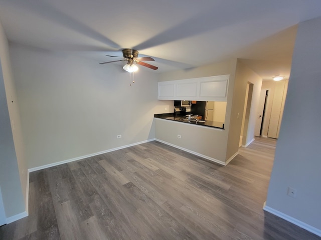 kitchen featuring ceiling fan, white cabinets, and hardwood / wood-style flooring