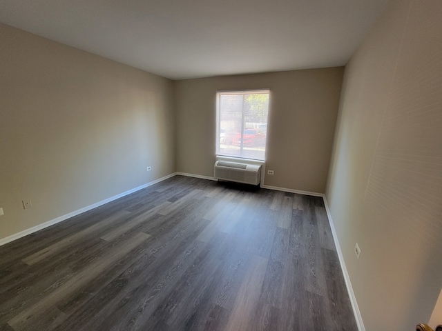 empty room with dark hardwood / wood-style flooring