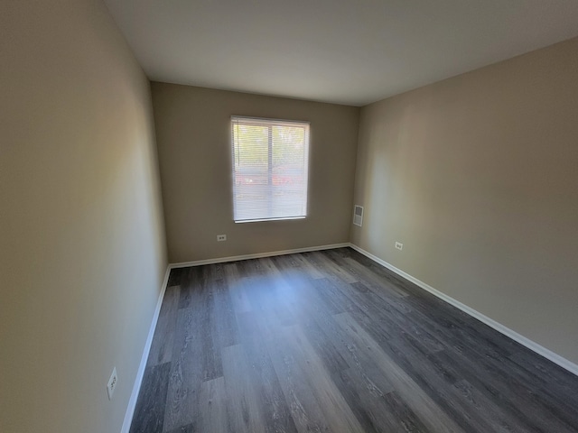 empty room featuring dark wood-type flooring