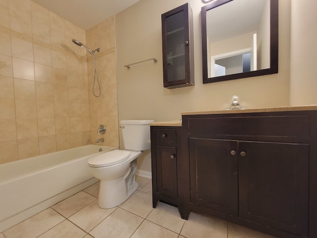 full bathroom featuring tile patterned flooring, vanity, tiled shower / bath combo, and toilet