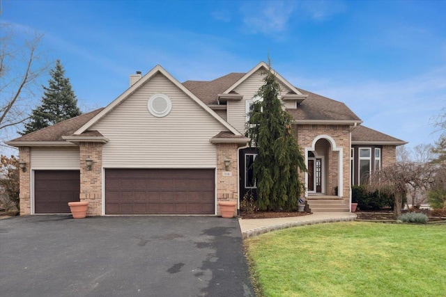 view of property featuring a front yard and a garage