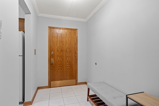 entryway with light tile patterned floors, a textured ceiling, and crown molding