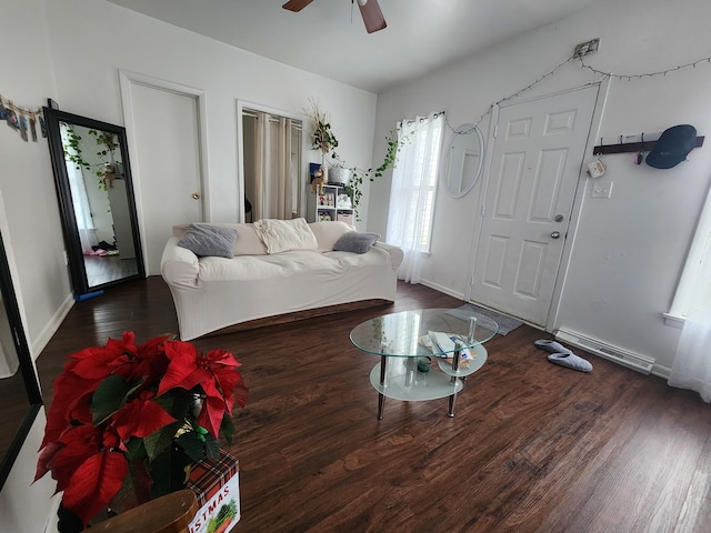 living room featuring ceiling fan and dark hardwood / wood-style floors