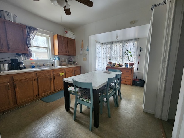 kitchen featuring ceiling fan and sink