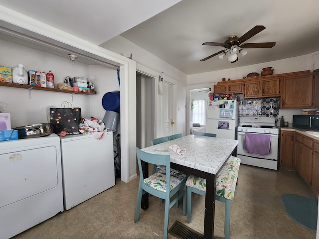 kitchen featuring white appliances, ceiling fan, and washing machine and clothes dryer