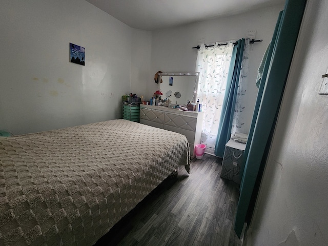 bedroom with dark hardwood / wood-style flooring