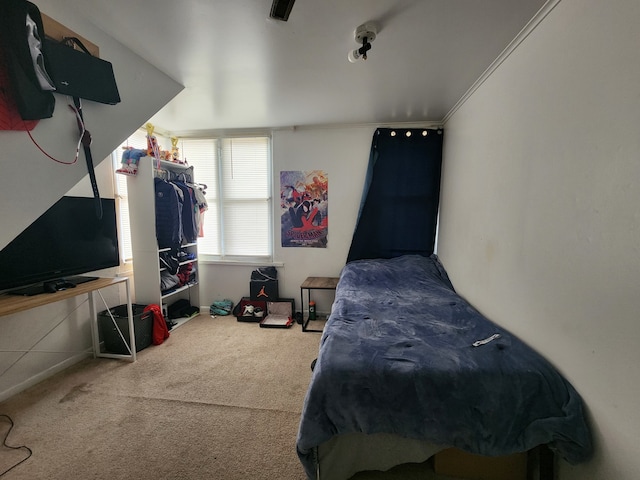 carpeted bedroom with ornamental molding