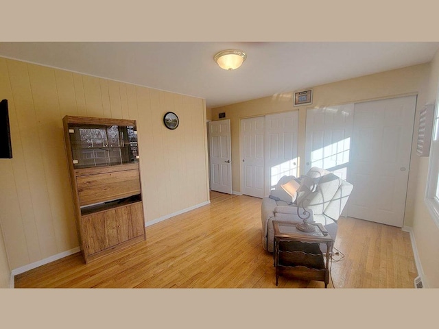 entryway with wooden walls and wood-type flooring