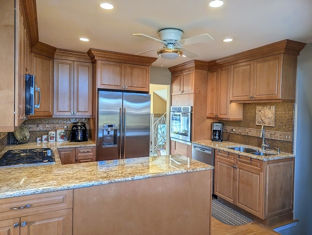 kitchen with light wood-type flooring, stainless steel appliances, tasteful backsplash, and sink