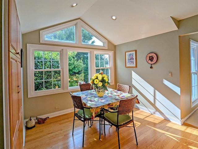 dining space featuring light hardwood / wood-style flooring and vaulted ceiling