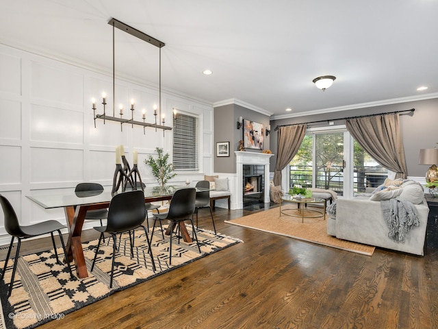 dining room with dark hardwood / wood-style floors and ornamental molding