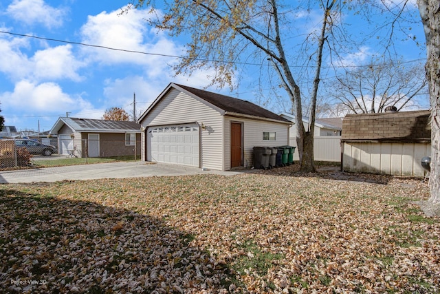 view of property exterior featuring a garage and an outbuilding