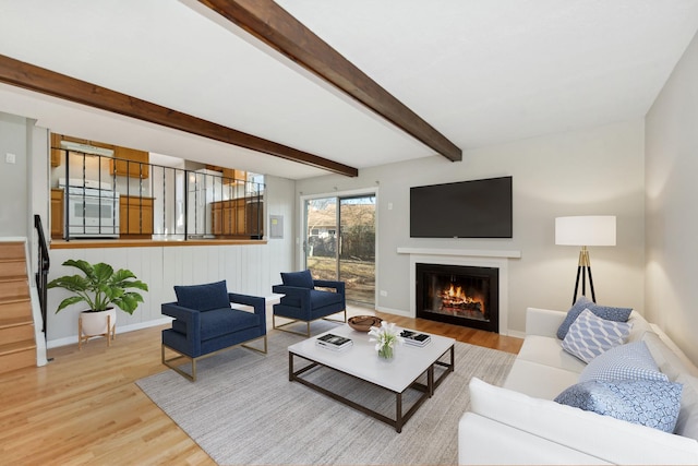 living room with beam ceiling and wood-type flooring