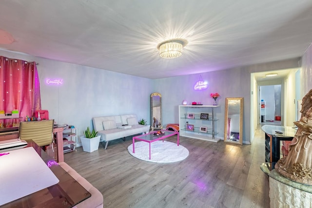 rec room featuring hardwood / wood-style flooring and a notable chandelier