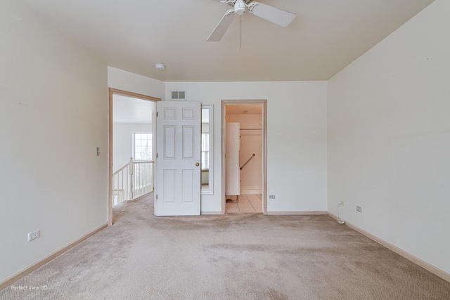 carpeted spare room with ceiling fan