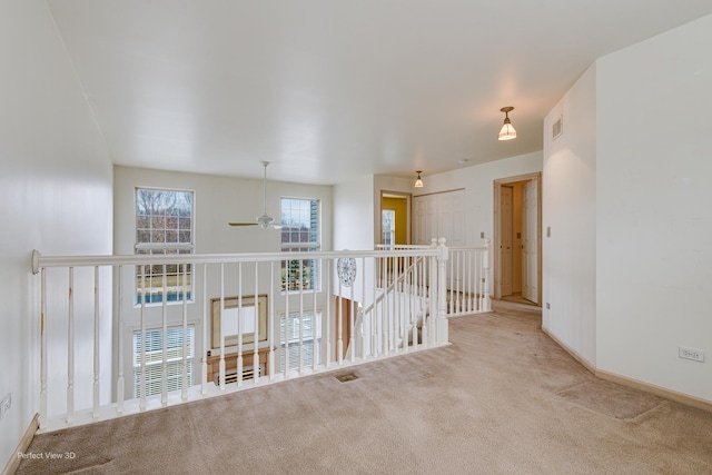 empty room with light carpet and ceiling fan