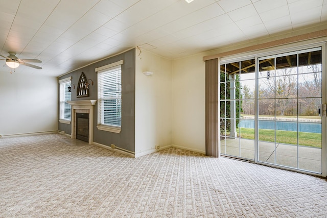 unfurnished living room with ceiling fan and carpet floors