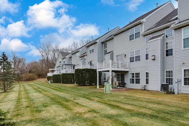 exterior space with a lawn and central AC